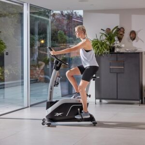 Reebok Fitness Upright Exercise Bike, Bluetooth Stationary Cycling Bike with 24 Resistance Levels, 12 Training Programs, Indoor Bike with Gel Pad Saddle